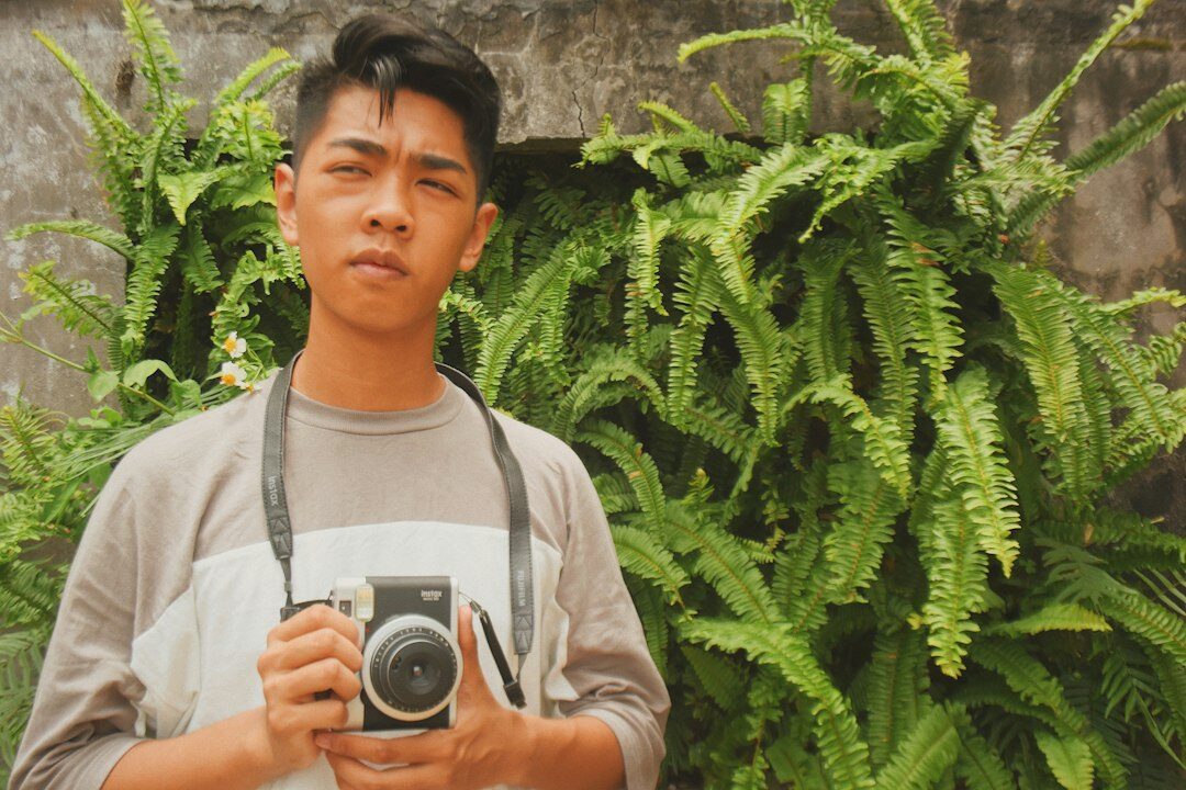 photographer with camera in village